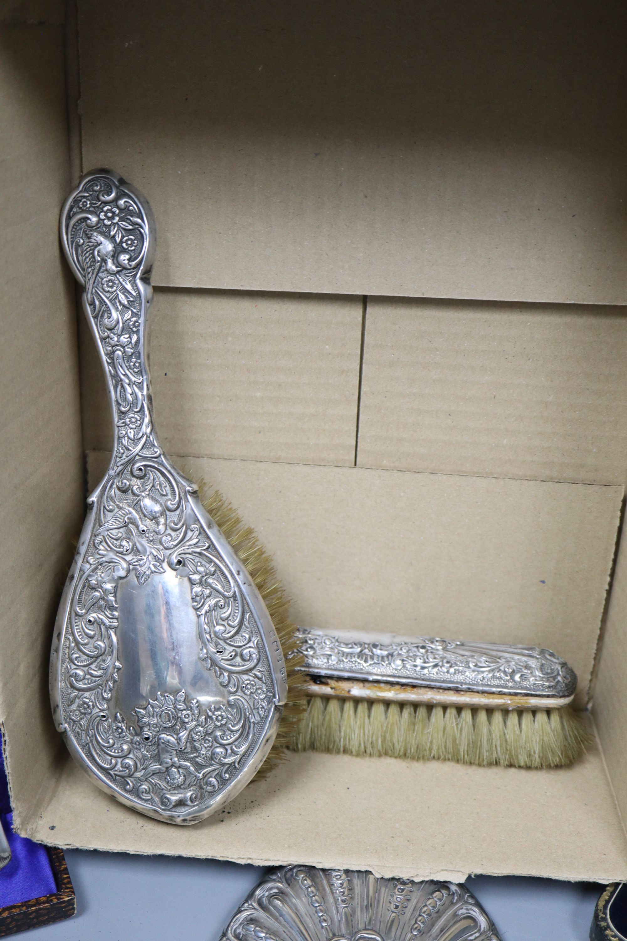 A late Victorian repousse silver mounted seven piece dressing table set by William Comyns, London, 1897/8, etc.